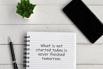 Wall Mural - Notepad with inspirational text - What is not started today is never finished tomorrow.