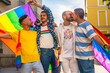 © unai - Homosexual friends having fun at gay pride party in the city, diversity of young people, demonstration with the rainbow flags, lgbt concept
