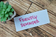 © syahrir - Concept of Friendly Reminder write on sticky notes isolated on Wooden Table.