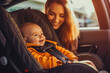 © VisualProduction - Smiling mother fastening seat belt on her newborn baby in a car seat, baby smiling and being happy. Generative AI