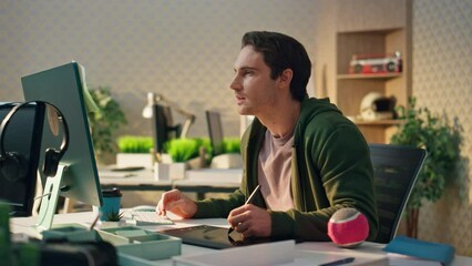 Wall Mural - Pensive creator watching computer screen at office. Freelance man using tablet