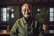 © Leon Waltz - Senior Japanese man in a green jacket and glasses smiling at the camera