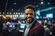 © Eber Braun - Medium shot portrait photography of a cheerful man in his 30s that is wearing a chic cardigan against a competitive video game tournament with players background .  Generative AI