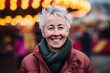 © Leon Waltz - Portrait of a happy senior woman at Christmas market in the city