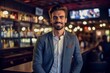 © Robert MEYNER - Portrait of a handsome young man standing in a pub and smiling