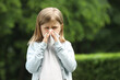 © New Africa - Little girl suffering from seasonal spring allergy outdoors, space for text