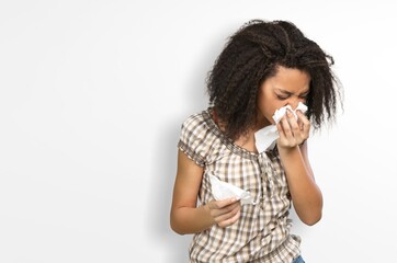 Portrait of a young sick woman sneezing,