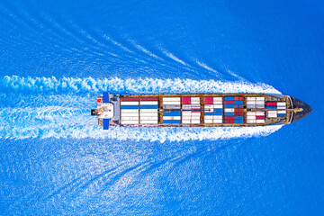 Wall Mural - Aerial top view of cargo maritime ship with contrail in the ocean ship carrying container and running for export concept technology freight shipping.