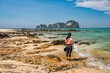© Noppasinw - Tropical islands view with woman tourist looking at ocean blue sea water and white sand beach at Bamboo Island, Krabi Thailand nature landscape