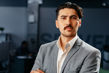 Canvas Print - Confident Arab businessman in formal clothes standing in office