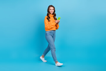 Canvas Print - Full length photo of shiny pretty lady dressed orange pullover writing sms twitter telegram facebook isolated blue color background