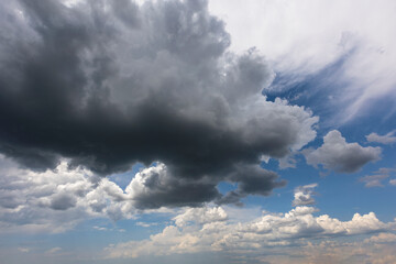 Wall Mural - blue sky with dark gray cumulus clouds background overlay. ideal for sky replacement