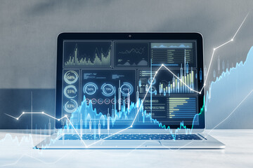 Fototapete - Close up of laptop computer at workplace with glowing candlestick forex chart on blurry background. Trade, finance and technology concept. Double exposure.