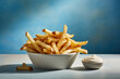  tasty and crunchy french fries on a plate with mayonnaise on a blue wall, created with generative ai