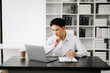© Nuttapong punna - Businessman using tablet and laptop for doing math finance on an office desk, tax, report, accounting, statistics, and analytical research concept in office