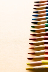 Canvas Print - Close up of multi coloured pencils and copy space on yellow background