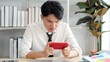 © M Stocker - Young asian businessman gamer playing online games on smartphone at office. businessman having serious stress while using smartphone playing online games