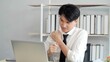 © M Stocker - Exhausted young asian male worker suffer from strain muscles, neck pain while working on laptop at office. Tired stressed man having neck pain. Office Syndrome concept