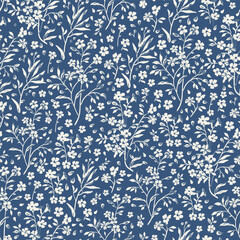 Seamless floral pattern for design. Small white flowers. Blue background. Modern floral texture. Floral pattern all over the body. An elegant template for fashionable prints.