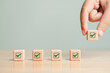 © Shutter2U - Wooden blocks checklist and green check mark icon with hand on table background. Business task sign appointment schedule concept. Businessman placing correct evaluation satisfaction checkbox symbol