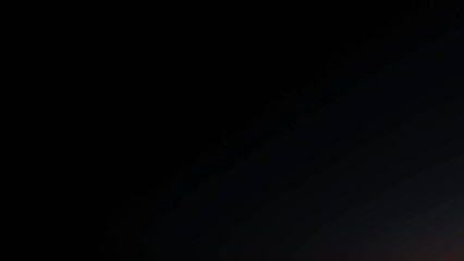 Wall Mural - a pervasive darkness dominates the surroundings until a glimmer of light emerges, piercing through t