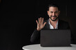 © Ranta Images - Portrait of handsome businessman using laptop computer to make video call
