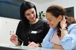 © Taras Grebinets - Smiling pleasant woman doctor dentist talking to a female patient, explaining the prescribed treatment, filling out forms standing at reception counter in modern dental clinic or outpatient hospital.