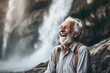 Lifestyle portrait photography of a grinning old man laughing against a majestic waterfall background. With generative AI technology