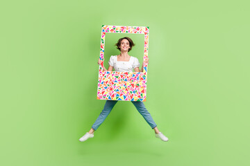 Canvas Print - Full size portrait of pretty cheerful girl jumping hold paper album set card isolated on green color background