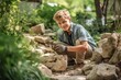 © Markus Schröder - Full-length portrait photography of a grinning boy in his 30s building or repairing something against a serene rock garden background. With generative AI technology
