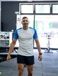 © Martí Rosselló - Portrait of a young male personal trainer smiling at the training center.