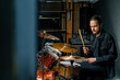 © Guys Who Shoot - a young male drummer plays a drum kit in a recording studio at a professional musician's rehearsal recording a song