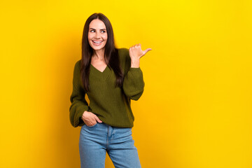 Poster - Photo of funky dreamy lady wear khaki pullover looking pointing thumb empty space isolated yellow color background