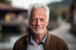 © Markus Schröder - Headshot portrait photography of a glad old man wearing an elegant long-sleeve shirt against a rustic bridge background. With generative AI technology