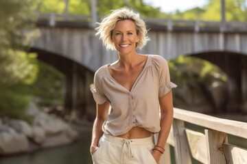 Wall Mural - Environmental portrait photography of a satisfied mature woman wearing breezy shorts against a rustic bridge background. With generative AI technology