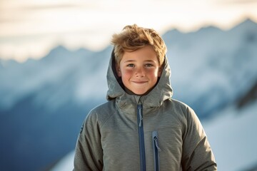 Wall Mural - Medium shot portrait photography of a happy kid male wearing a comfortable hoodie against a serene snow-capped mountain background. With generative AI technology