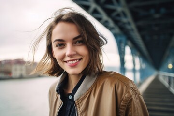 Wall Mural - Close-up portrait photography of a joyful girl in her 30s wearing a sleek bomber jacket against a scenic riverboat background. With generative AI technology