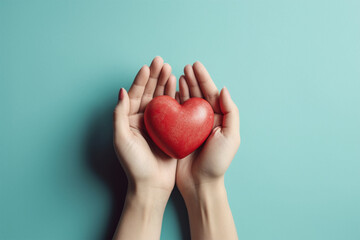 Wall Mural - woman hands holding red heart on pastel isolated background.top view.copy and text space.created wit