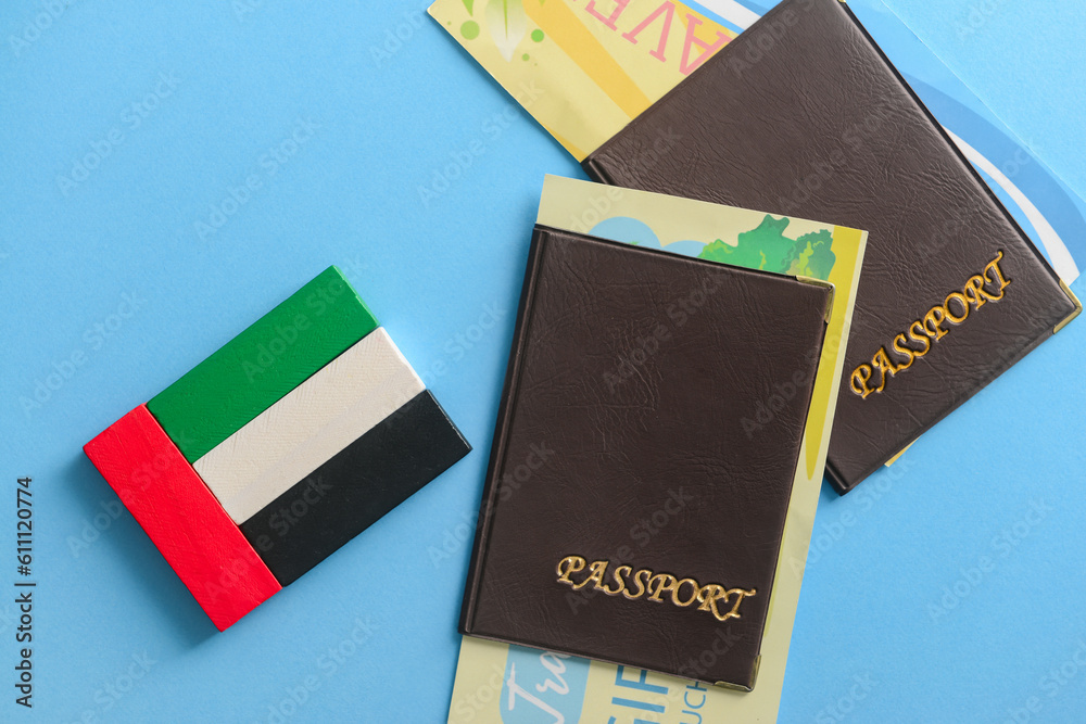 UAE flag made of blocks and passports on blue background