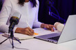 © DragonImages - Female blogger writing down script before recording video for her blog