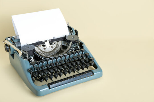 Vintage typewriter on beige background