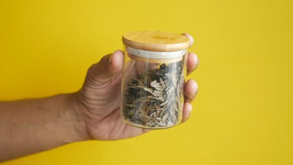 Canvas Print - men holding a jar of tea leaves 