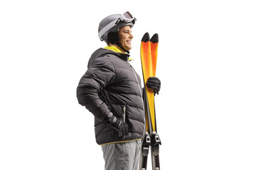 Canvas Print - Profile shot of a man holding a pair of skis