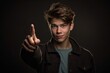 © Markus Schröder - Medium shot portrait photography of a glad boy in his 20s making a i'm thinking gesture with the finger on the temple against a dark grey background. With generative AI technology