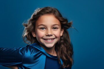 Wall Mural - Headshot portrait photography of a grinning kid female posing like a superhero against a sapphire blue background. With generative AI technology