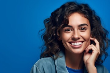 Close-up portrait photography of a happy girl in her 20s making a telephone call gesture with the hand against a periwinkle blue background. With generative AI technology