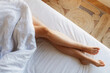 © ProstoSvet - Beautiful female legs on the bed. Vacation concept