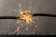 sparks explosion between electrical cables, fire hazard concept