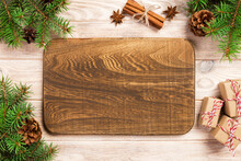 Wood Cutting Board At Table Background With Christmas Decoration, Round Board. New Year Concept