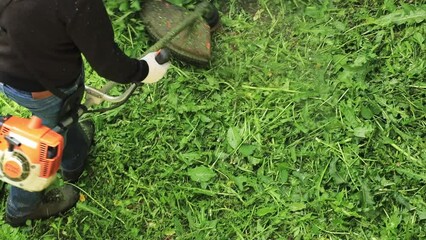 Poster - man mowing grass with a trimmer